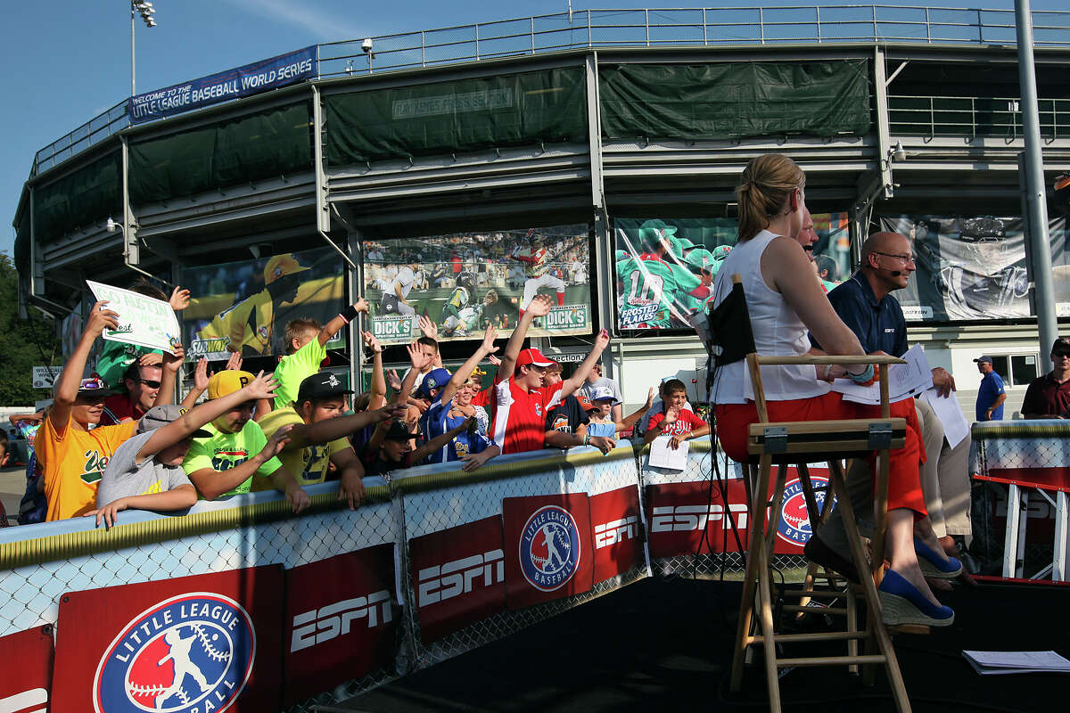 Players, fans and family gather by the ESPN broadcast area for an opportunity to be on live television on the first day of the 2012 Little League World Series in South Williamsport, Pa., Thursday, Aug. 16, 2012. San Antonio's McAllister Park National Little League team, representing the Southwest Champions, will face off with the Mid-Atlantic Champions from Parsippany, New Jersey, Friday afternoon.