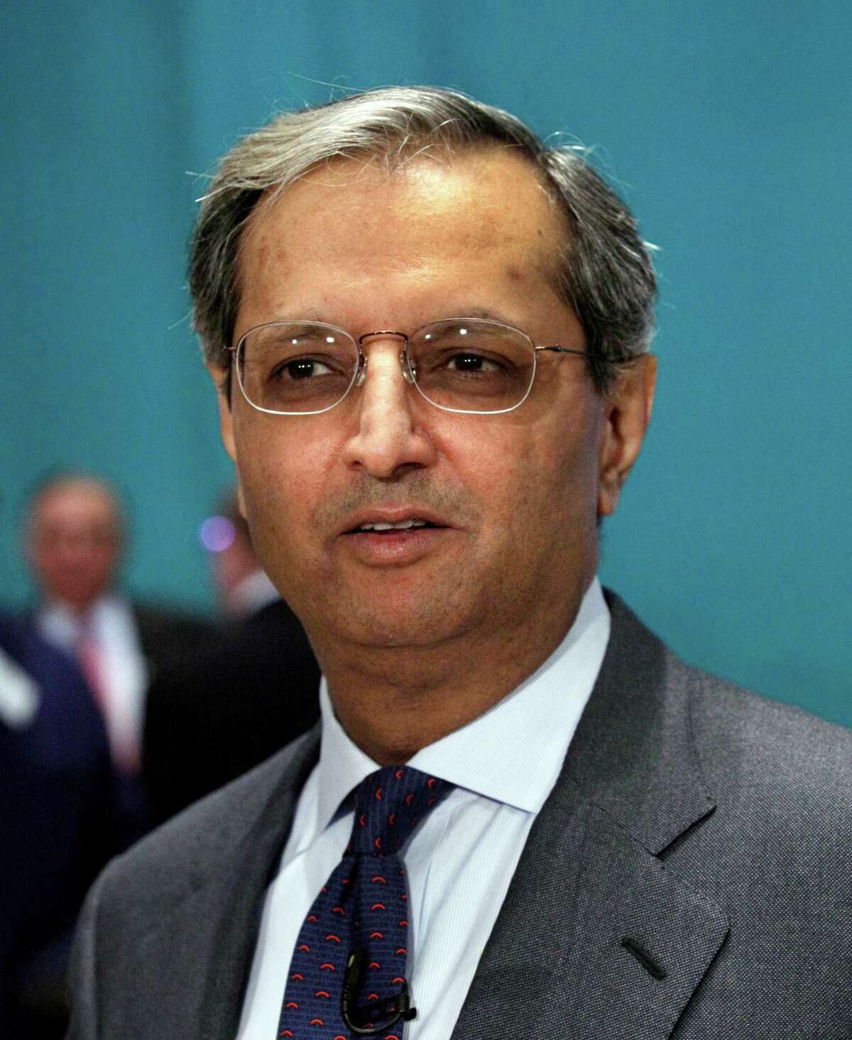 FILE - In a Monday, June 18, 2012 file photo, Citigroup CEO Vikram Pandit prepares for a television interview on the floor of the New York Stock Exchange, after he rang the opening bell. Twenty-six big U.S. companies paid their CEOs more last year than they paid the federal government in tax, according to a study released Thursday, Aug. 16, 2012 by the Institute for Policy Studies. The study said the companies, including AT&T, Boeing and Citigroup, paid their CEOs an average of $20.4 million last year while paying little or no federal tax on ample profits, according to regulatory filings. The study also laid into Citigroup for paying Pandit $14.9 million while the bank received a net $144 million in tax benefits. (AP Photo/Richard Drew, File)