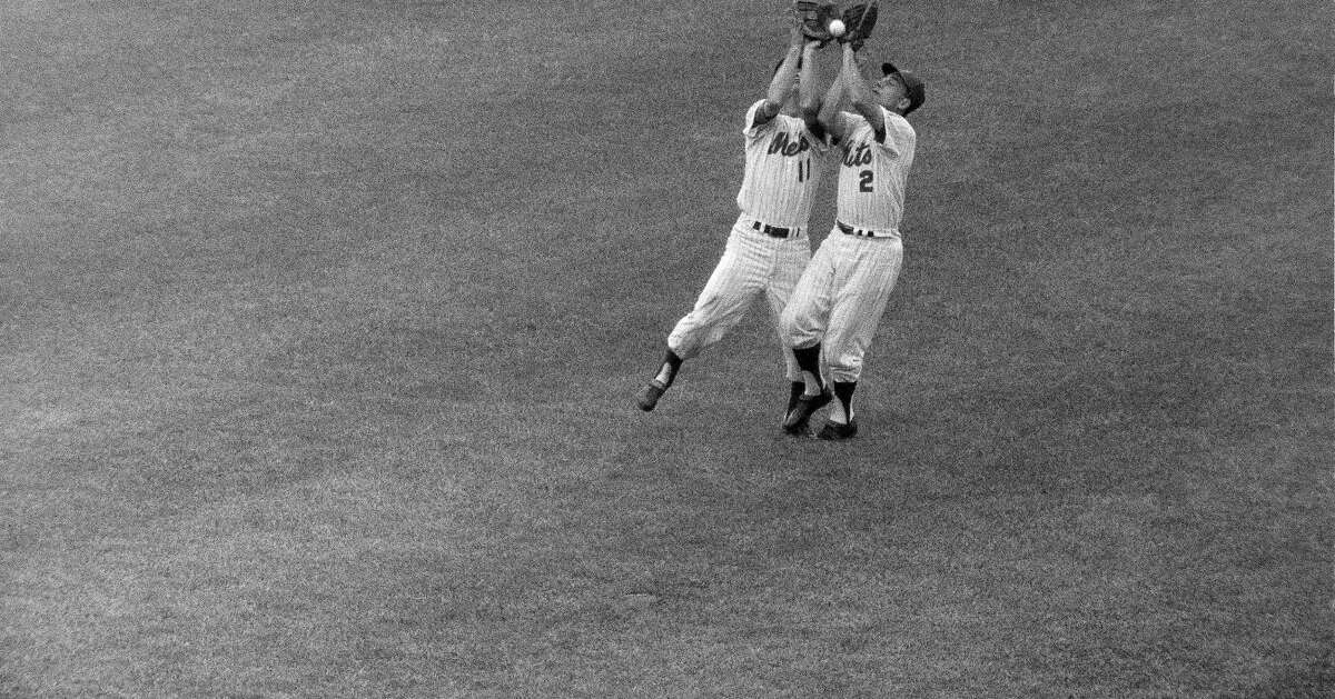 Even in their fourth season, the New York Mets remained woefully bad, dropping 112 games - the team's fourth consecutive 100-loss season - and turning plays like this one on which shortstop Roy McMillan, left, and second baseman Chuck Hiller collided as they tried to field a popup, resulting in an error.