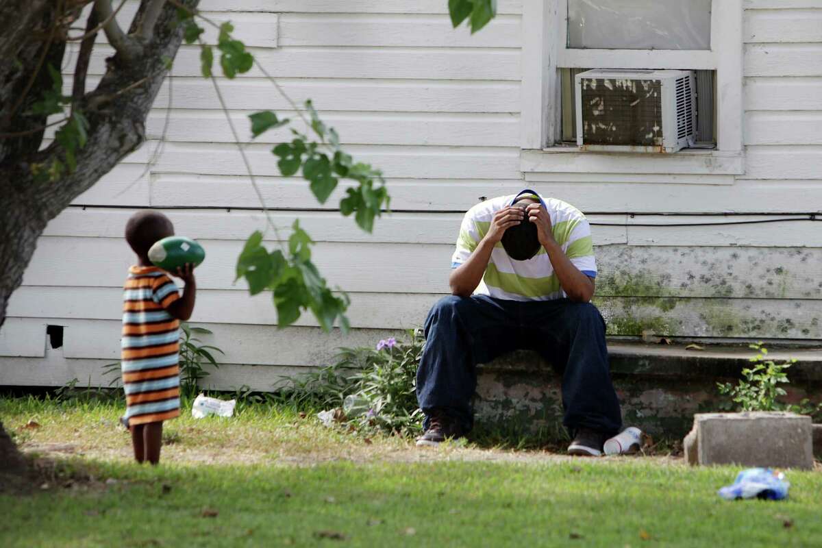 A family member sits outside the home where Houston Police as they investigate the death of a child found inside a home on Thursday morning in the 2300 block of Hutton near Quitman on Thursday, Aug. 16, 2012, in Houston. HPD has not resealed any further information to what may have led to the death. ( Mayra Beltran / Houston Chronicle )