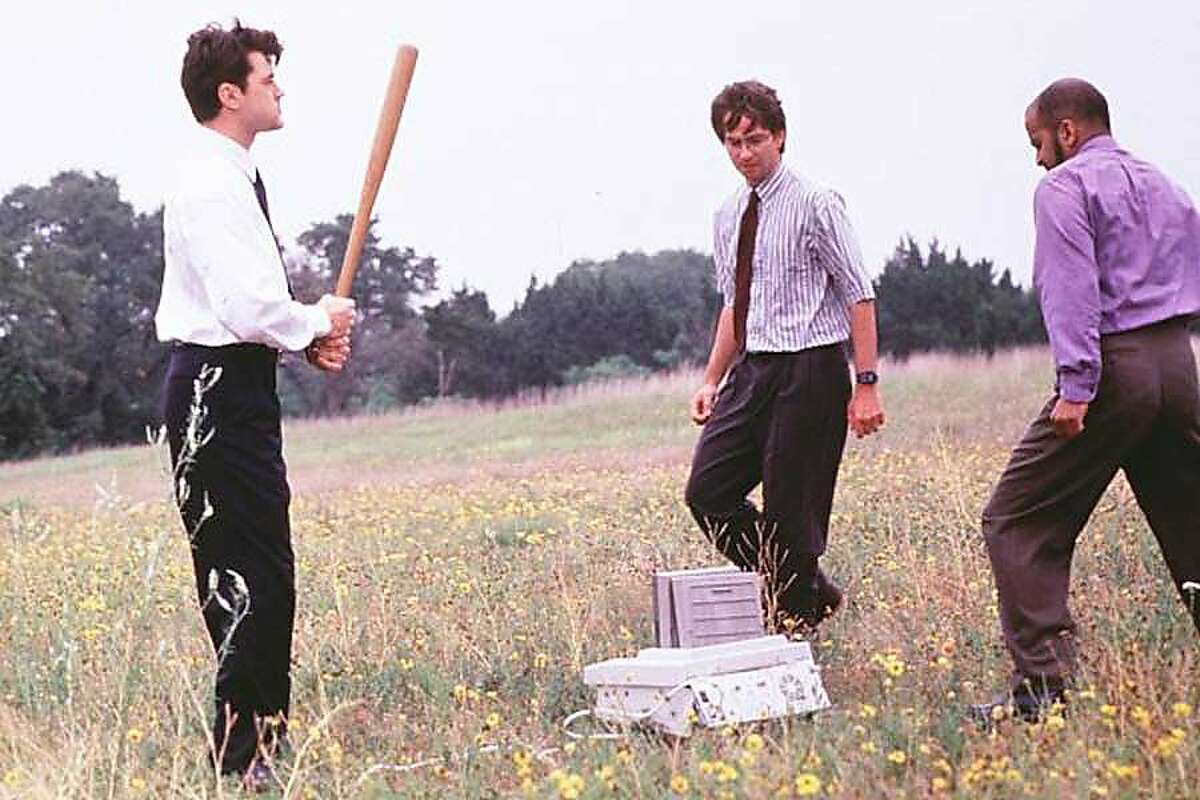 Office Space (1999). (L to R) Ron Livingston, David Herman and Ajay Naidu showing some love to an office fax machine. HO Ran on: 08-31-2006 Leave your work at work this holiday weekend.