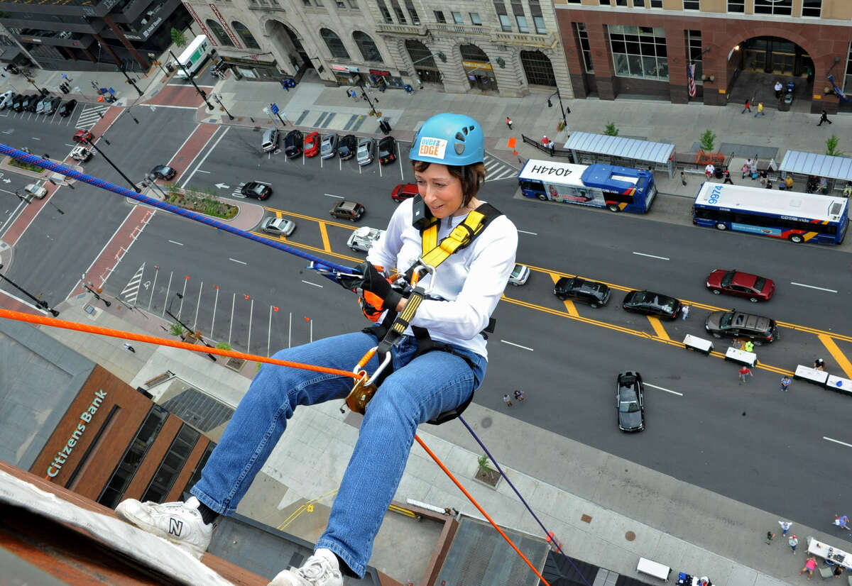 Helena DeCaprio of Schenectady rappels down the 18 story side of Hotel Albany for the Over The Edge event to benefit the Special Olympics on Friday, Aug. 17, 2012 in Guilderland, N.Y. (Lori Van Buren / Times Union)