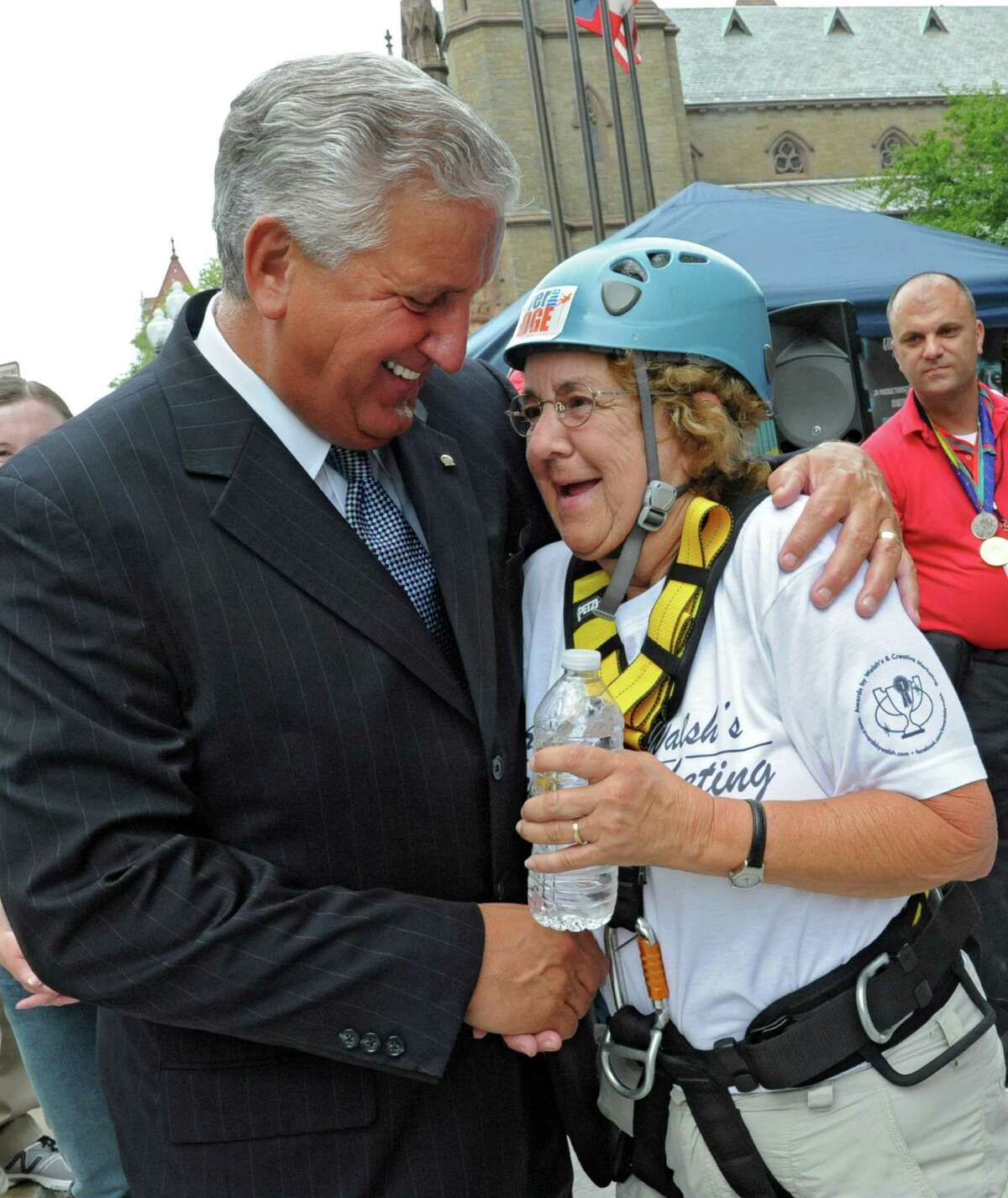 Albany Mayor Jerry Jennings congratulates 70-year-old Gail Wrieden of Latham after she rappelled down the 18 story side of Hotel Albany for the Over The Edge event to benefit the Special Olympics on Friday, Aug. 17, 2012 in Guilderland, N.Y. (Lori Van Buren / Times Union)