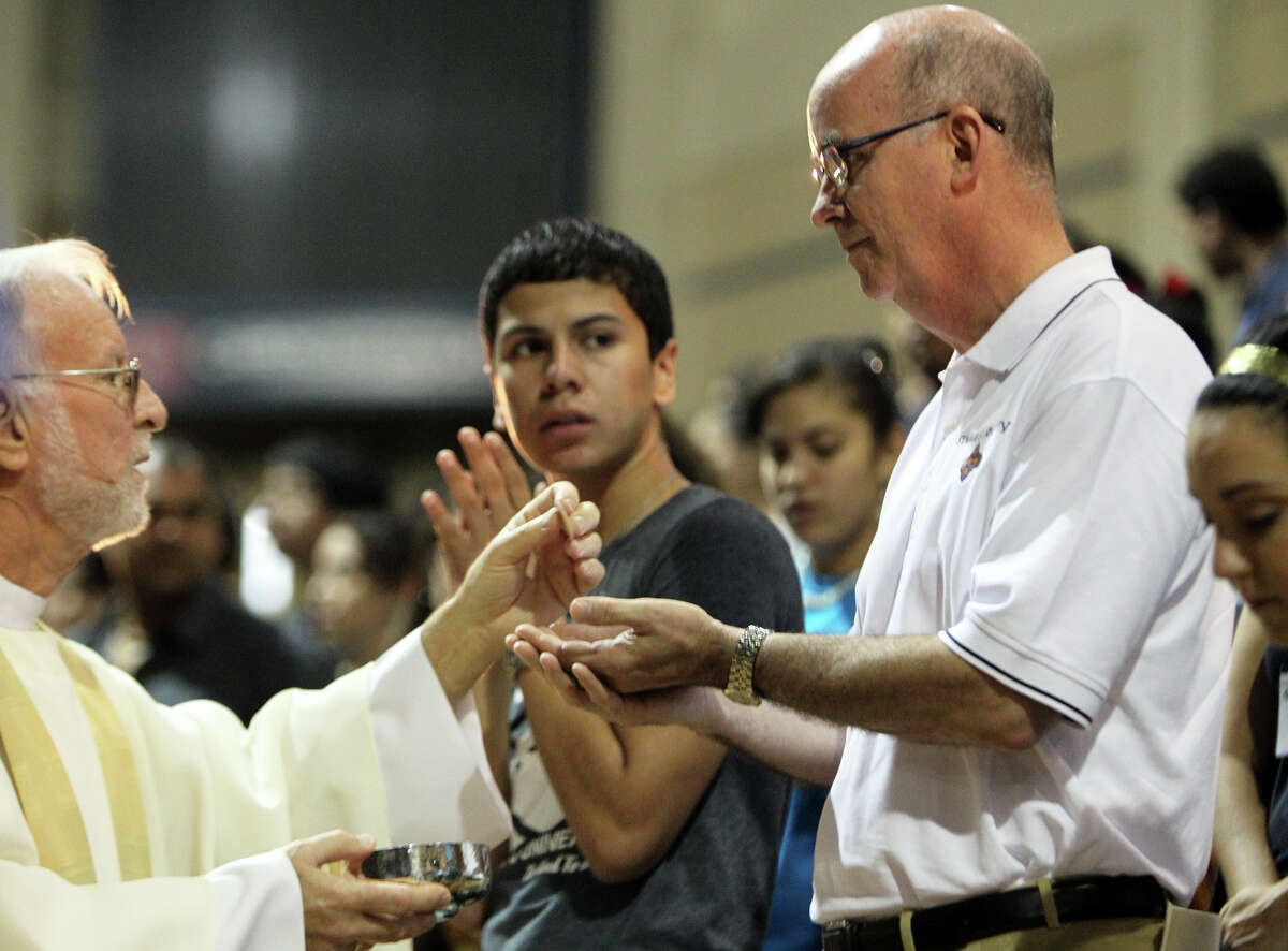 Thomas Mengler, who just took over as the 13th president of St. Mary's University, participates in a Convocation and Eucharist Celebration as part of orientation for new students at Bill Greehey Arena at St. Mary's University, August 18, 2012. (JENNIFER WHITNEY)