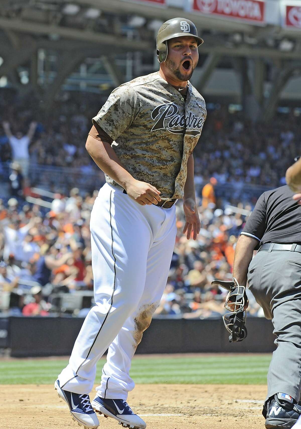 Yonder Alonso #23 of the San Diego Padres celebrates after scoring during the first inning of a baseball game against the San Francisco Giants at Petco Park on August 19, 2012 in San Diego, California. (Photo by Denis Poroy/Getty Images)
