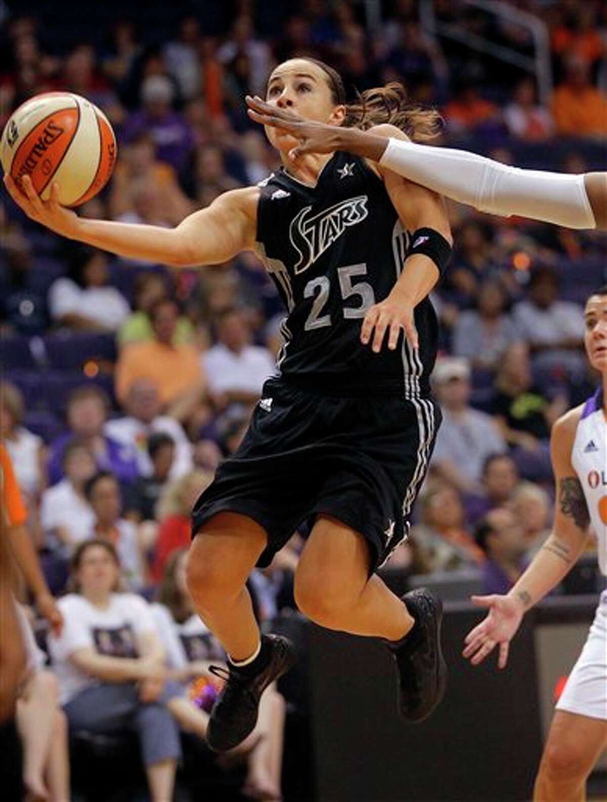 San Antonio Silver Stars guard Becky Hammon (25) drives against the Phoenix Mercury during the first half of a WNBA basketball game on Sunday, Aug. 19, 2012, in Phoenix. (AP Photo/Matt York)