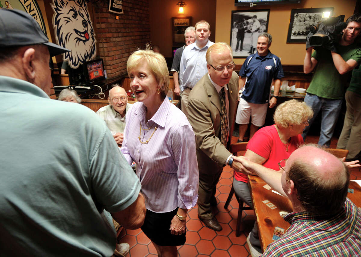 Linda McMahon, Republican candidate for U.S. Senate, greets William Duncan, left, as Danbury Mayor Mark Boughton greets Thomas Kalbfus during McMahon's visit to T.K.'s American Cafe in Danbury on Wednesday, Aug. 15, 2012 the day after McMahon won the Republican primary.