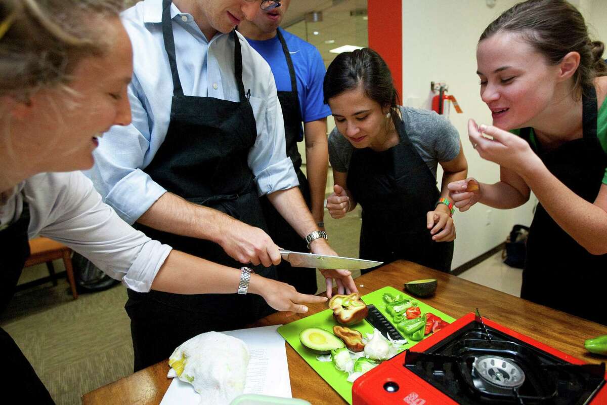 Second-year medical students, from left, Barcleigh Sandvall, Jeremy Slawin, Christopher Chu, Marina Masciale and Kailey Bolles work to create a pepper and avocado soup in a cooking class at Baylor College of Medicine.