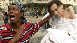 (High Res.)  Sarah Johnson screaming my patient is not dead, my patient is not dying,all she needs is oxygen as she seeks help at the Convention Center in New Orleans during  aftermath of Hurricane Katrina Thursday,  Sept. 1, 2005.  Thousands of people wait outside the Convention Center to be taken to safety.  Sarah provides in-home care for the woman and did not want to give the patients' name. (Melissa Phillip / Chronicle)     HOUCHRON CAPTION (09/02/2005) SECNEWS:  DESPERATION: Screaming "My patient is not dead, my patient is not dying! All she needs is oxygen!" Sarah Johnson seeks help at the Ernest N. Morial Convention Center for the woman she cares for, whom she declined to identify.