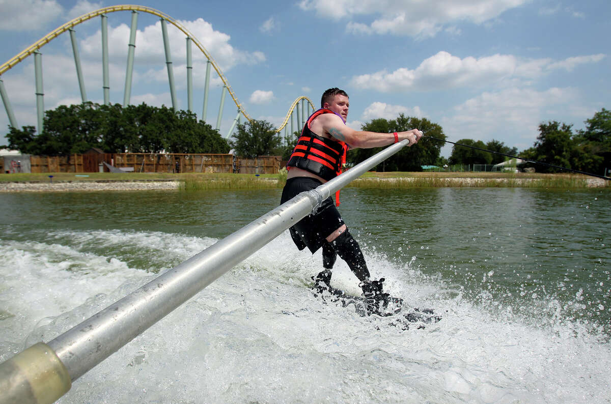 “All Can Ski,” a waterskiing clinic for people with physical disabilities that’s sponsored by San Antonio Sports, is celebrating its 20th anniversary. Tuesday’s event on the ski lake at SeaWorld included wounded military men and women, many of whom are being treated at the Center for the Intrepid. Jason Rzepa cruises under the roller coaster track on a ski run as volunteers help with All Can Ski at SeaWorld.