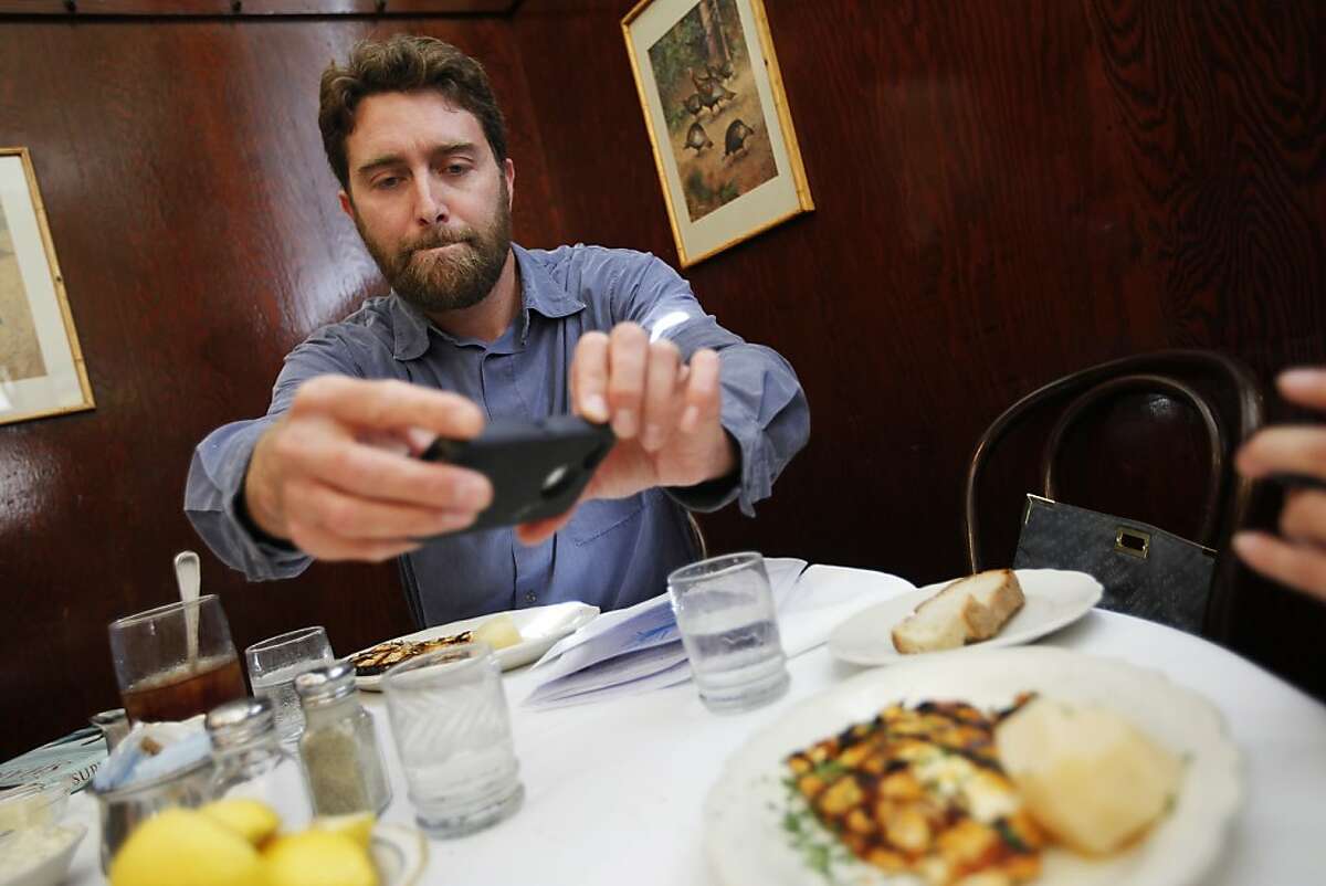 Geoff Shester, California Program Director at Oceana, photographs the ordered meals to document the research. San Francisco, Calif. on Wednesday, Aug 15, 2012.
