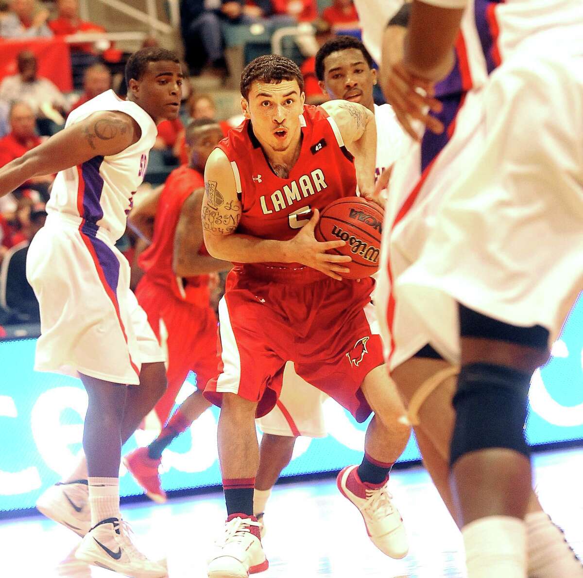 Lamar's Mike James barrells through the SFA defense at the Merrell Center in Katy, Thursday, March 8, 2012. Tammy McKinley/The Enterprise