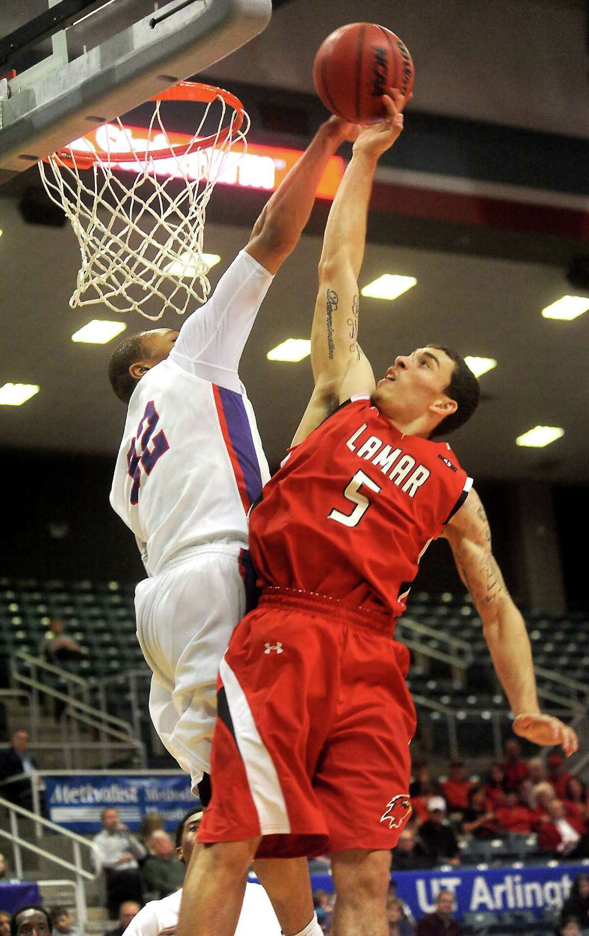 Lamar's Mike James goes for the basket as SFA's Taylor Smith tries to block at the Merrell Center in Katy, Thursday, March 8, 2012. Tammy McKinley/The Enterprise