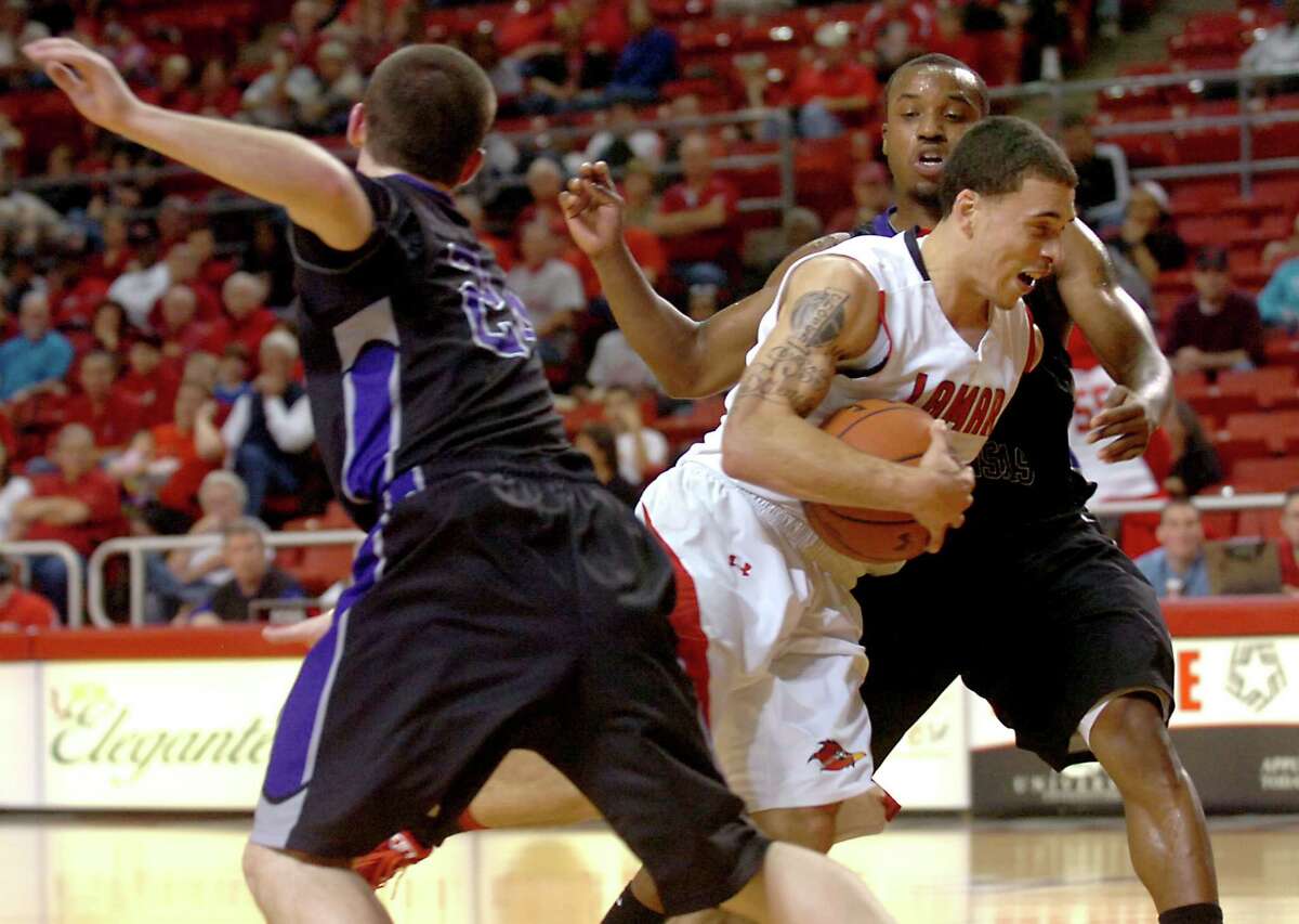 Lamar's Mike James powers throught Central Arkansas' Dewan Clayborn and Carlin Bremner at the Montagne Center at Lamar University in Beaumont, Saturday, January 7, 2012. Tammy McKinley/The Enterprise