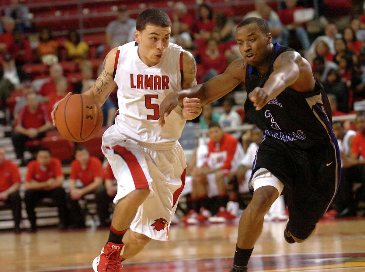 Lamar's Mike James and Central Arkansas' Dewan Clayborn race down the court at the Montagne Center at Lamar University in Beaumont, Saturday, January 7, 2012. Tammy McKinley/The Enterprise