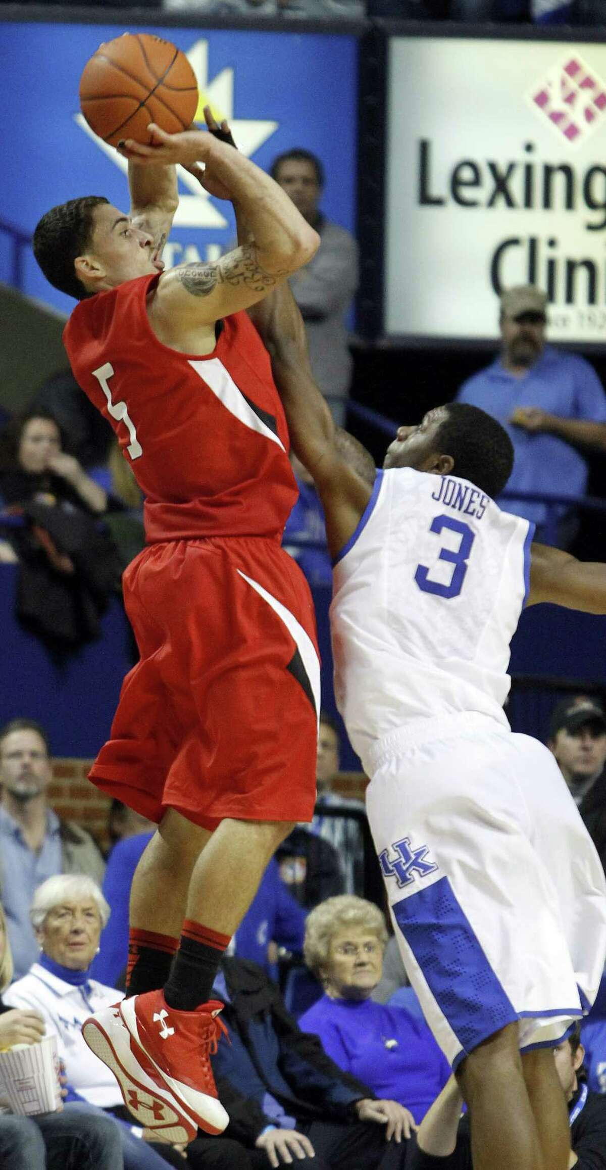 Lamar's Mike James, left, shoots under pressure from Kentucky's Terrence Jones during the second half of an NCAA college basketball game in Lexington, Ky., Wednesday, Dec. 28, 2011. Kentucky won 86-64. (AP Photo/James Crisp)