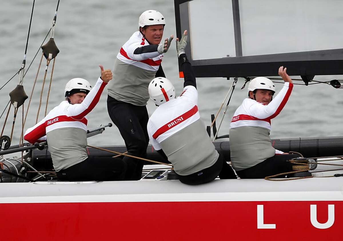 The Luna Rossa Swordfish crew celebrates after crossing the finish line during the America's Cup World Series on Wednesday, August 22, 2012 in San Francisco, Calif.