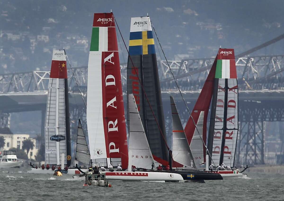 Italy's Luna Rossa Piranha faces off against Sweden's Artemus Red boat (center) while China's team chases Italy's Luna Rossa Swordfish boat (background) in the qualifying round of competition for the America's Cup World Series of yacht racing in San Francisco, Calif. on Wednesday, Aug. 22, 2012.