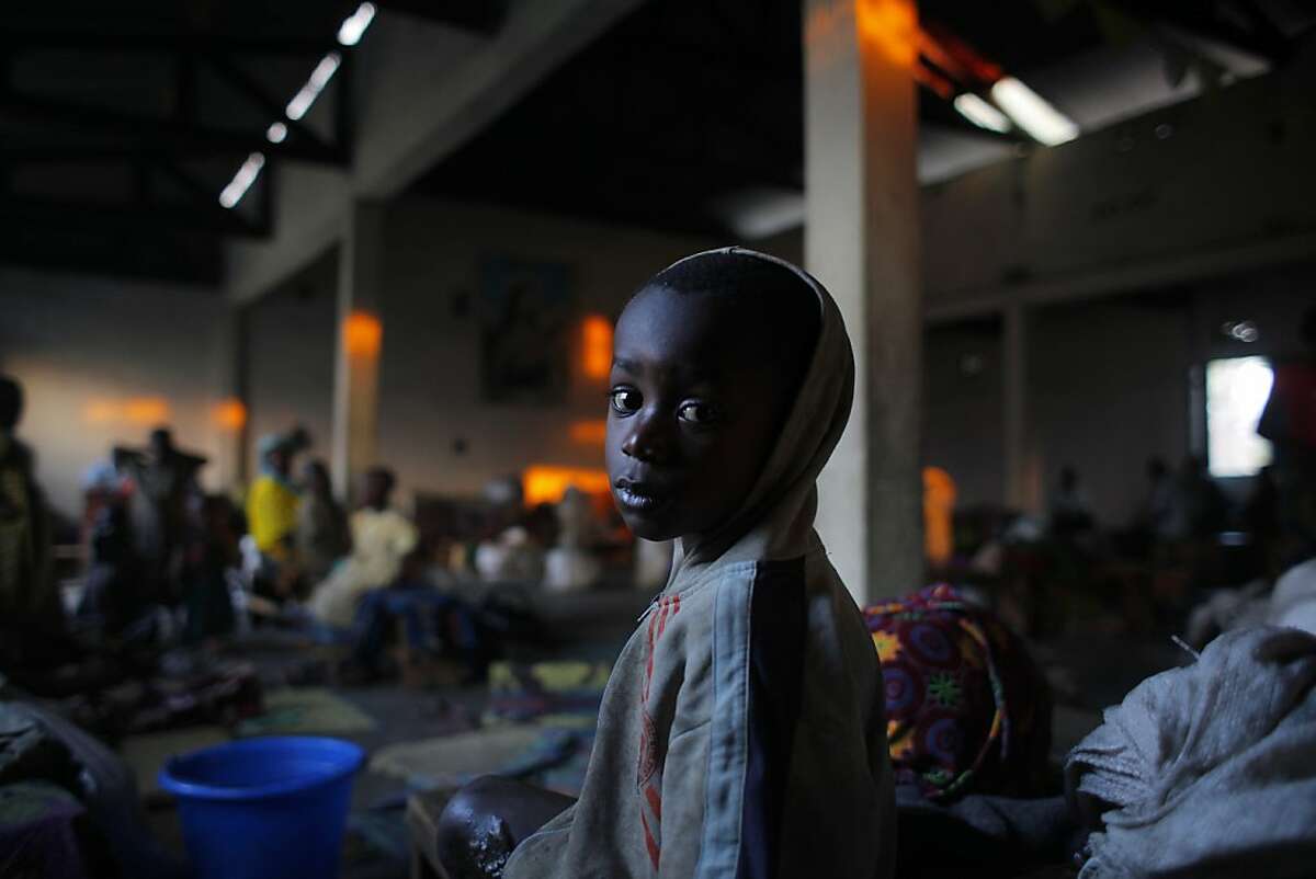 A internally displaced Congolese child sits in the church where he and others found refuge on the outskirts of Goma, eastern Congo, Friday, Aug. 3, 2012. The first case of cholera has emerged among thousands of people in an impromptu refugee camp in eastern Congo who fled fighting between a new rebel group and government forces backed by U.N. peacekeepers, Doctors Without Borders reported. Congo's army now controls only the city of Goma and the village of Kibumba, 10 kilometers (six miles) outside Goma. Now the rebels hold all towns going north as far as Rutshuru and are threatening to besiege Goma. The U.N. Security Council on Thursday demanded that the M23 rebel group halt any advances toward Goma. (AP Photo/Jerome Delay)