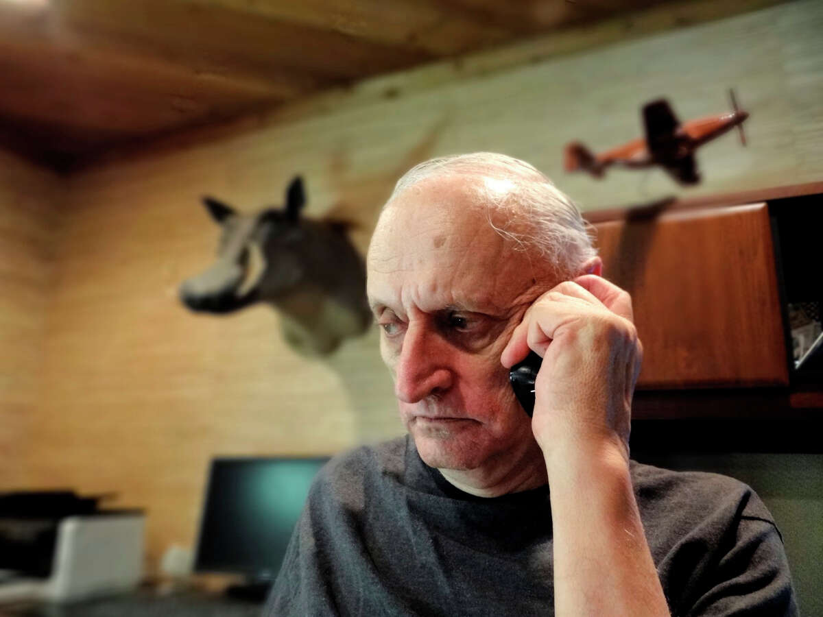 Retired Doctor Charles Arnold makes a phone call regarding a case in which he was scammed out of a large amount of money. Aug. 22, 2012.
