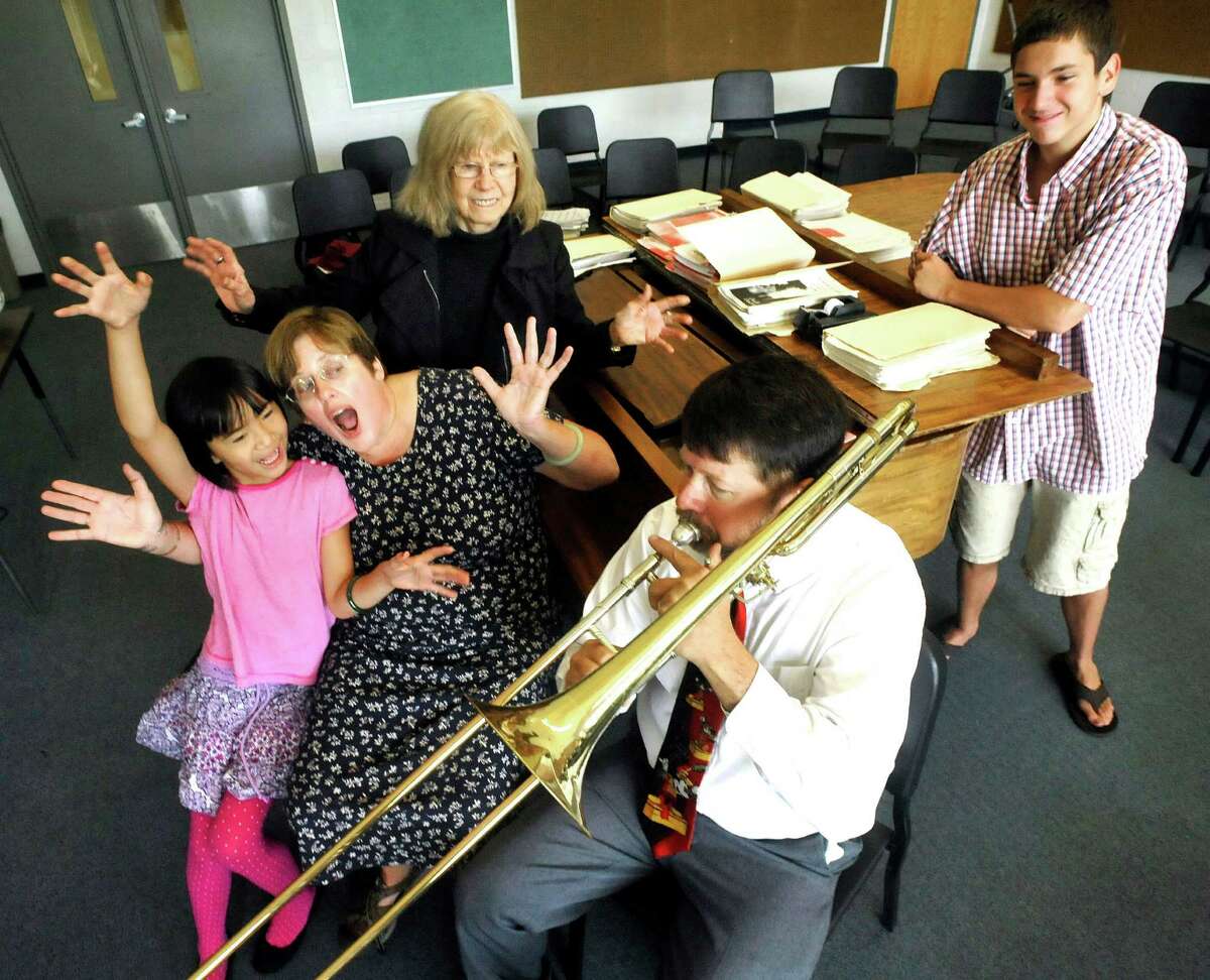 New Milford Teacher of the Year, Michael Fitzgerald, performs to the delight of his family in the music room at New Milford High School Friday, Aug. 24, 2012. From left are Hannah, 9, Michael's wife, Margaret, his mother Rosemarie, Michael, and Andrew Fitzgerald, 14.