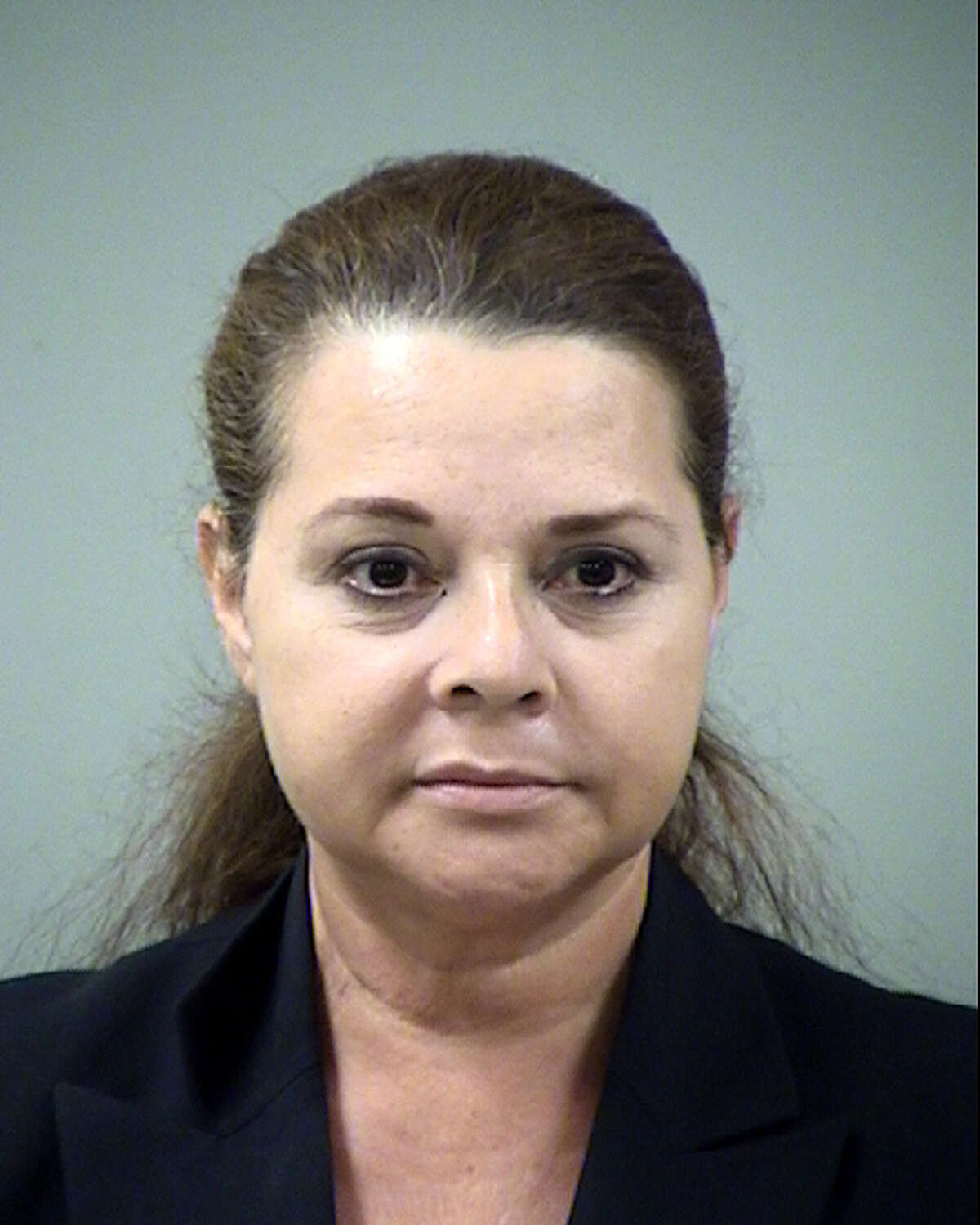 Hilda Valadez is seen in an Aug. 23, 2012 Bexar County Sheriff's Department booking mug taken after she was charged with 46 felony counts that include forging judges' signatures and double-billing the county.