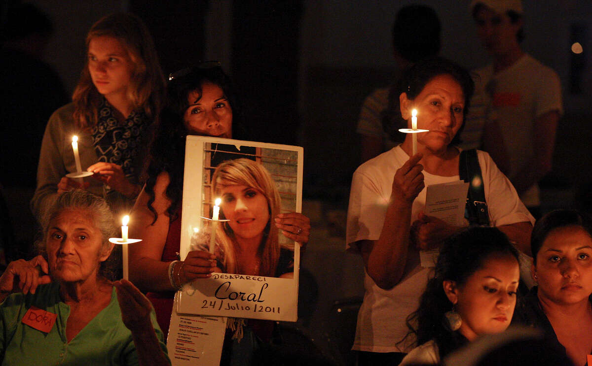 People participate in a candlelight vigil as part of the Caravan for Peace with Justice and Dignity held Friday Aug. 24, 2012 at St. Leonard Parish Hall.