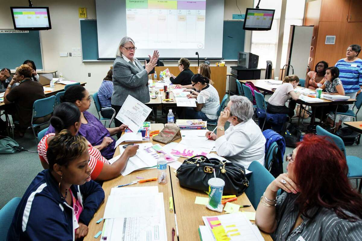 Dr. Regina Gooden, center, teaches a class of HISD teachers during a professional development program at the Neuhaus Education Center, Wednesday, Aug. 22, 2012, in Houston. ( Michael Paulsen / Houston Chronicle )