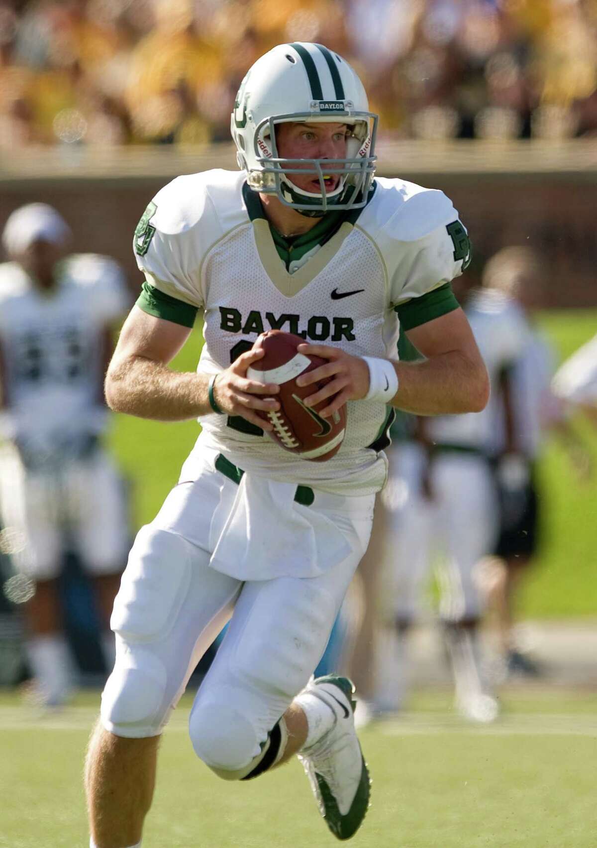 FILE - In this Nov. 7, 2009, file photo, Baylor quarterback Nick Florence tries to find an open receiver as he runs during the first quarter of an NCAA football game against Missouri in Columbia, Mo. The Baylor Bears are looking for Nick Florence to be more than a second-half fill-in for Heisman Trophy winner Robert Griffin III this season. (AP Photo/L.G. Patterson, File)