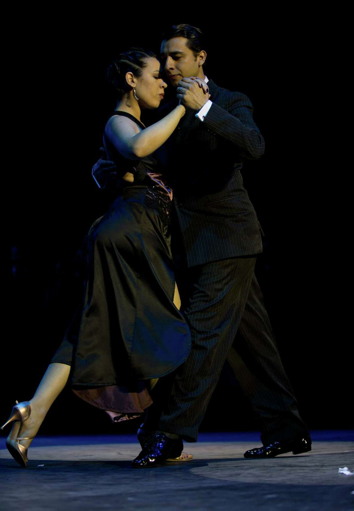 Argentina's couple Facundo de la Cruz Gomez Palavecino, right, and Paola Sanz dance after winning the 2012 Tango Dance World Cup salon finals in Buenos Aires, Argentina, Monday, Aug. 27, 2012. Couples from around the world competed in the finals Argentina's annual tango competition, the highlight of a two-week festival which this year honored Astor Piazzolla, the legendary composer and bandoneonista who revived the genre and infuriated purists by blending tango with rock music in the 1970s.