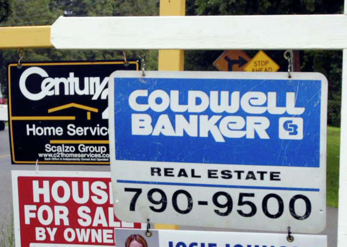 File photo : Real Estate for sale signs on a traffic triangle on Coal Pit Hill Rd in Danbury on the border of Bethel.