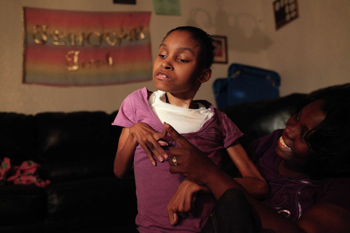 Zabrina Priestley, who evacuated to San Antonio from New Orleans after Hurricane Katrina and has made her home in San Antonio, spends time with her daughter, Alexandra "Lexi" Gibson, 24, who has cerebral palsy, at her home on Tuesday, August 28, 2012. Gibson had to be carried above the floodwaters in her wheelchair to a boat during the aftermath of Katrina.