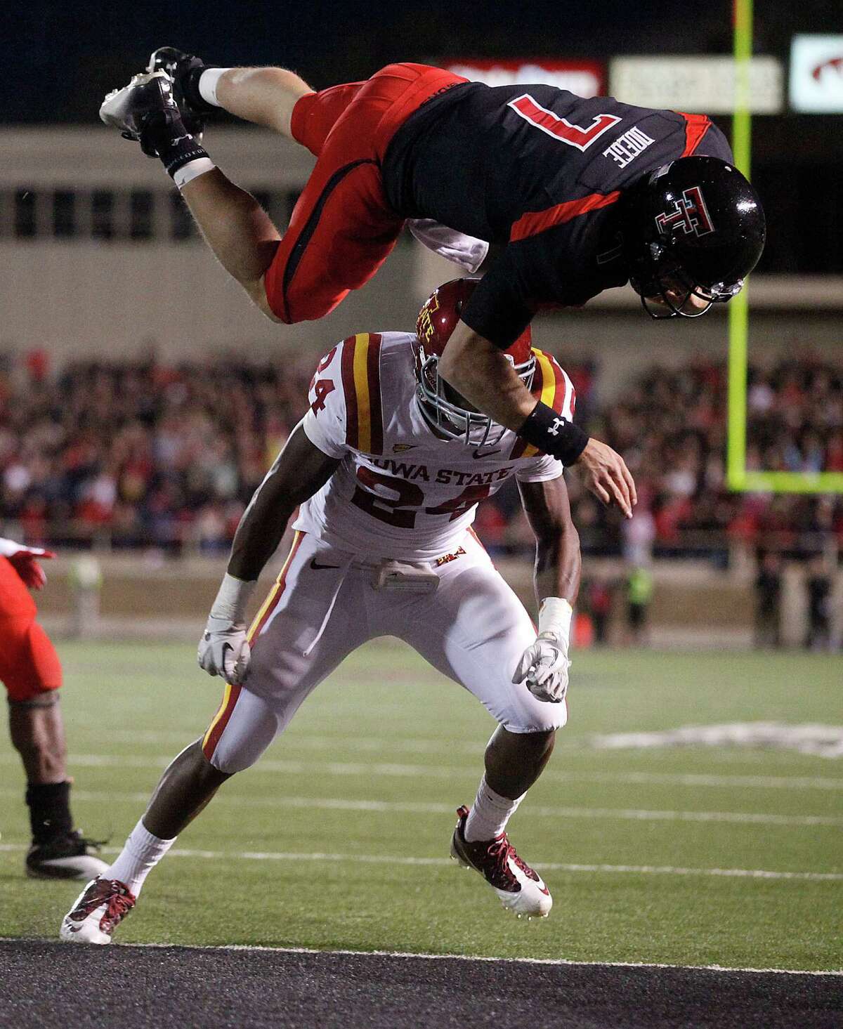 Texas Tech's Seth Doege (7) dives for a touchdown over Iowa State's Durrell Givens (24) during an NCAA college football game, in Lubbock, Texas, Saturday, Oct. 29, 2011. (AP Photo/Lubbock Avalanche-Journal, Stephen Spillman)