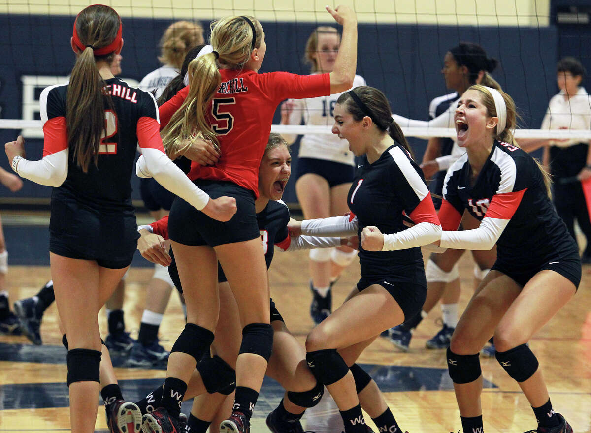The Chargers celebrate a kill as Churchill beats Smithson Valley 3-0 at Smithson Valley gym on August 28, 2012.