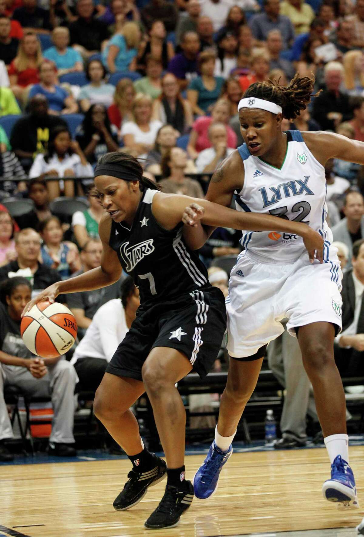 San Antonio Silver Stars guard Jia Perkins (7) tries to keep the ball in bounds against Minnesota Lynx forward Rebekkah Brunson (32) in the second half of a WNBA basketball game, Tuesday, Aug. 28, 2012, in Minneapolis. The Lynx won in overtime 96-84. AP Photo/Stacy Bengs