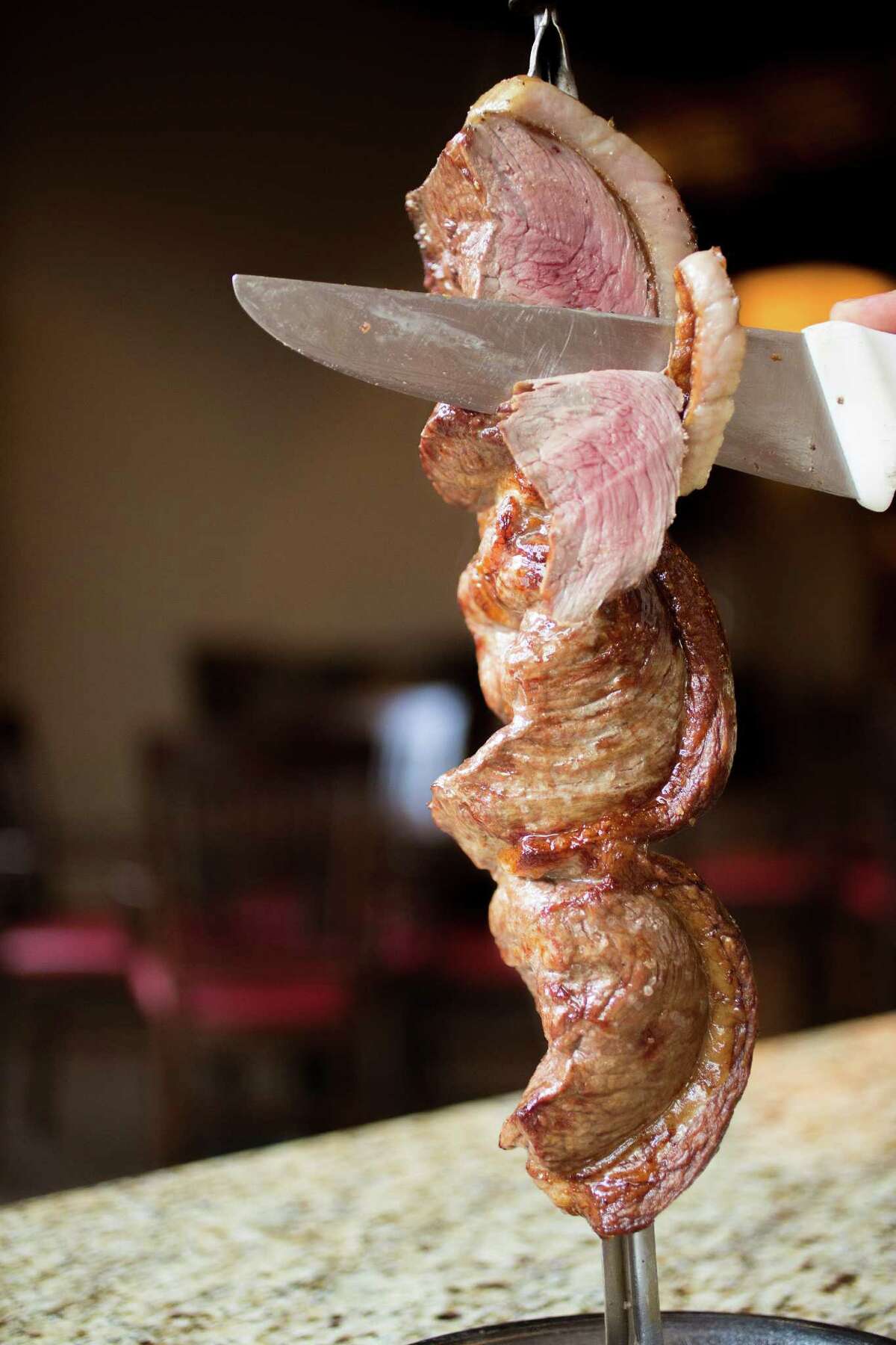 Meat is sliced right off the skewer at Chama Gaúcha.