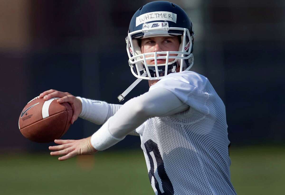 FILE - In this Aug. 3, 2012, file photo, Connecticut quarterback Chandler Whitmer throws during the team's first NCAA college football practice of the season in Storrs, Conn., Connecticut opened practice with Whitmer, a junior-college transfer, as the No. 1 quarterback on the depth chart. Whitmer got the nod this week on the strength of his performance in UConn's spring game, in which he completed 18 of 27 passes for 187 yards (AP Photo/Jessica Hill, File)