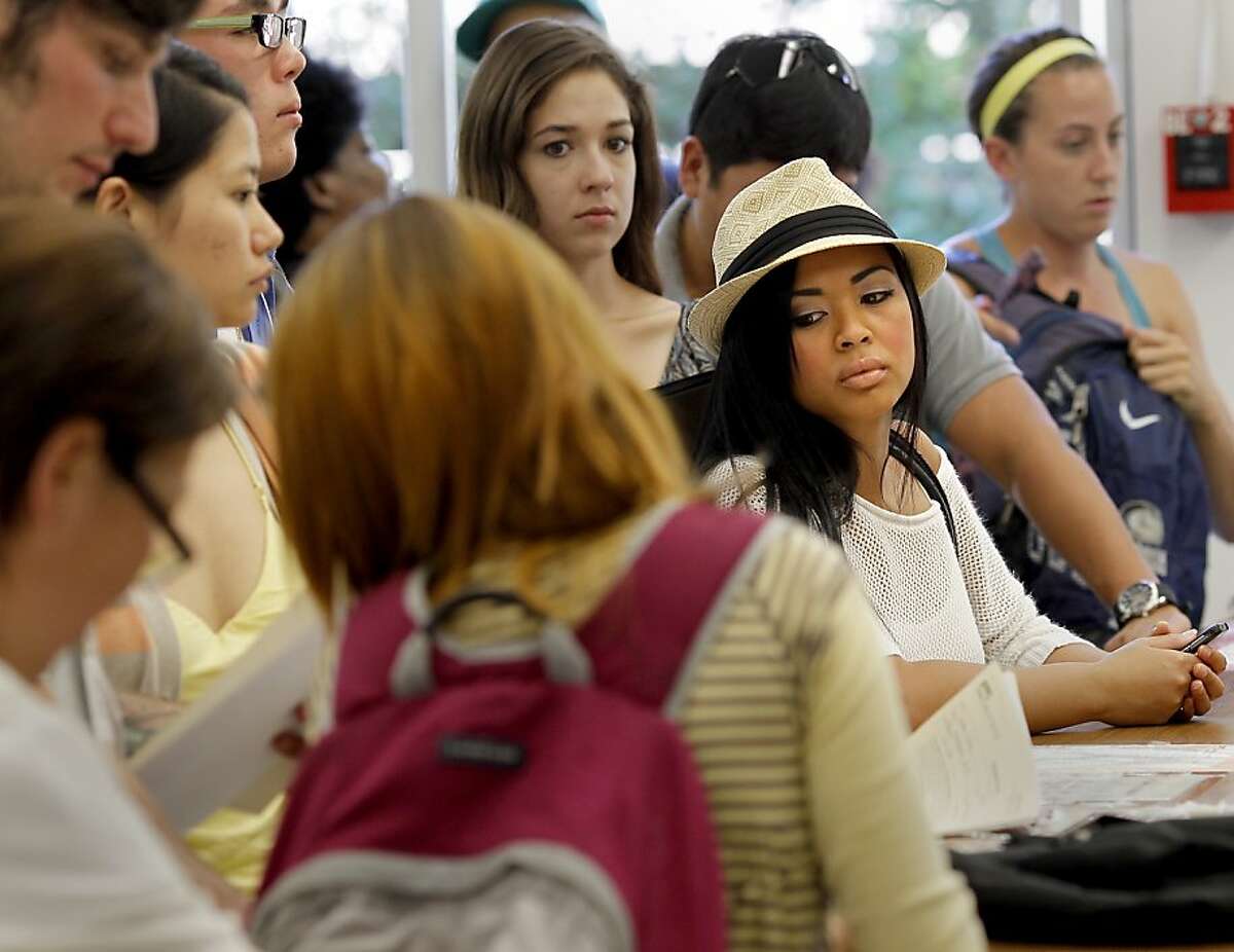 Eleanor Ipil (center in white hat) and other students waited in the Admissions office late in the day to file changes to their classes. Community Colleges like Diablo Valley Community College in Pleasant Hill, Calif. are losing students because of budget cuts resulting in fewer classes and fewer staff.