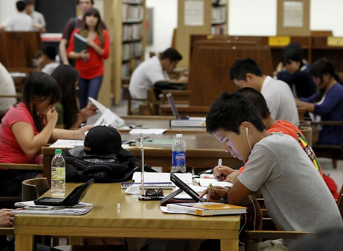 Kaito Saki (right) and others were busy in the library near the end of the day at Diablo Valley. Community Colleges like Diablo Valley Community College in Pleasant Hill, Calif. are losing students because of budget cuts resulting in fewer classes and fewer staff.
