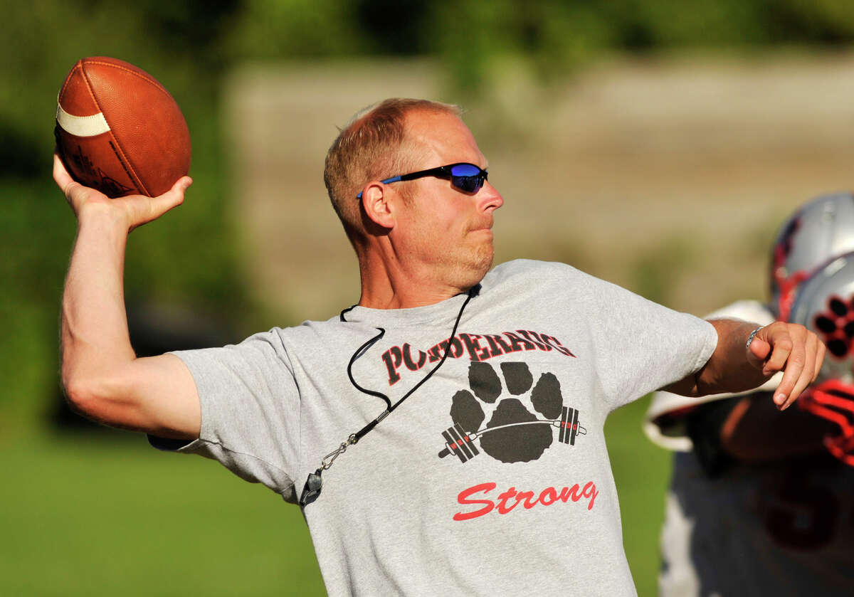 Pomperaug High School football coach David Roach throws the ball during practice in Southbury on Wednesday, Aug. 29, 2012.