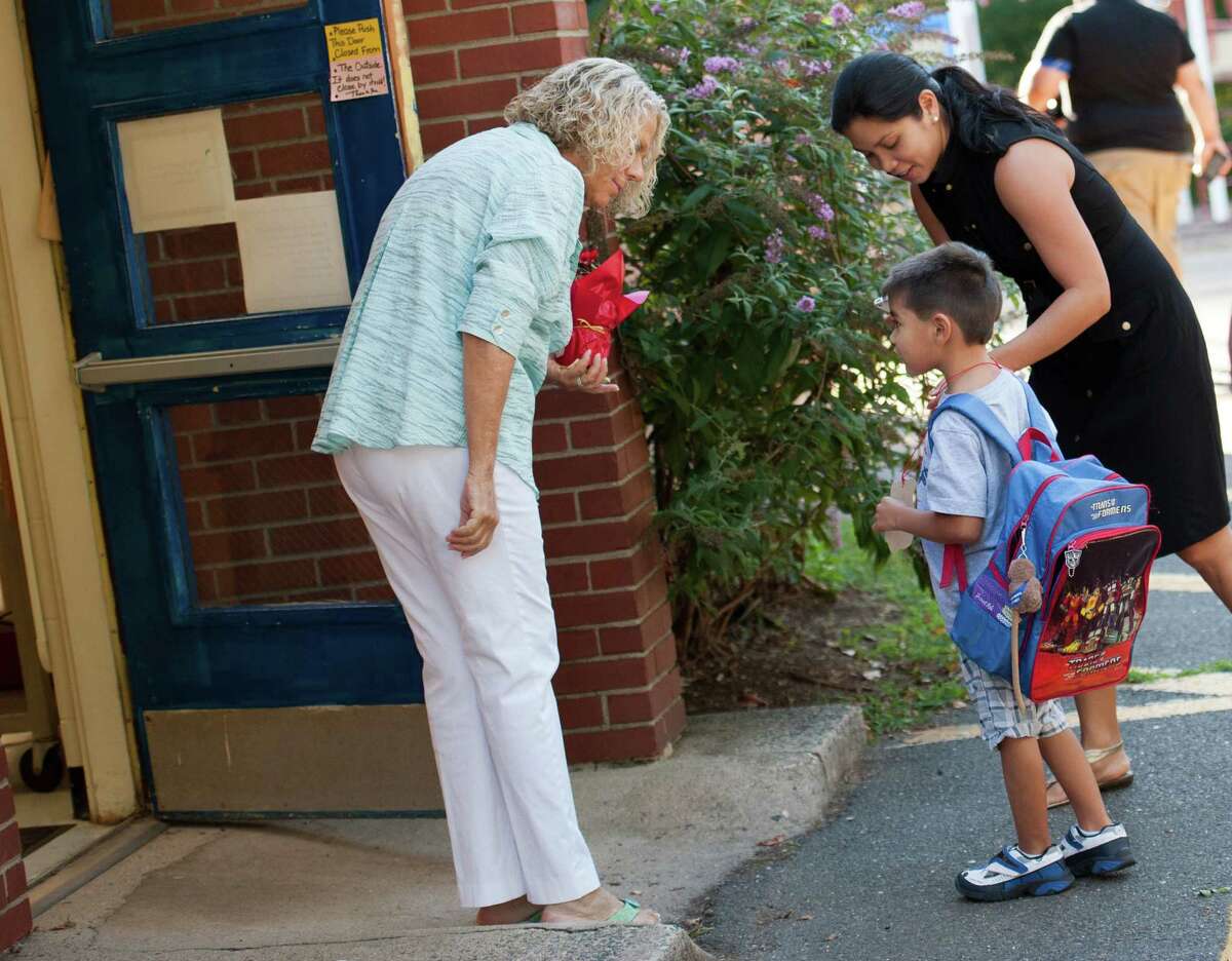 A floral arrangement in hand, Holland Hill kindergarten teacher Fran Wilder was outside greeting her new students on the first day of school Thursday.