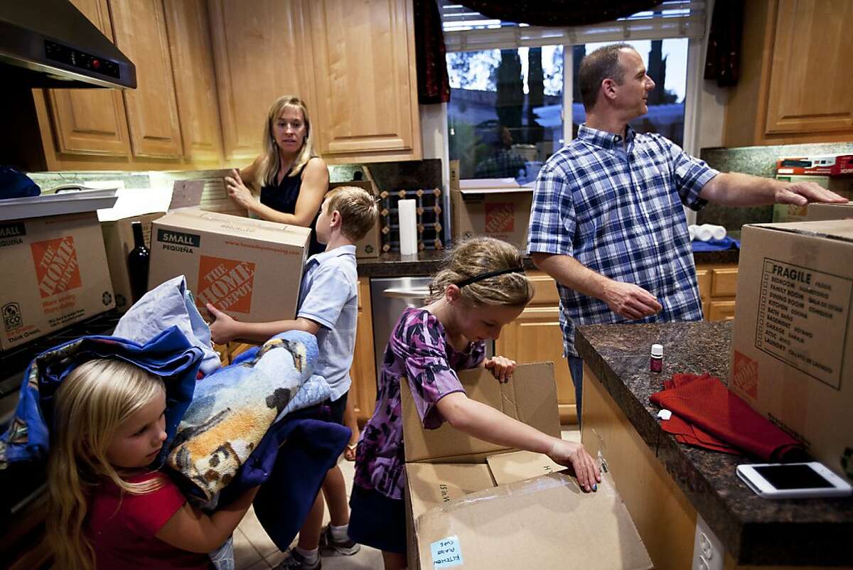 Erick and Nichole Ormsby are unpacking with their three children (l-r) Taylor, 5, Connor, 9, and Hannah, 7. They moved into a bigger house in Danville after selling their San Ramon house. Danville, Calif. on Thursday, Aug 23, 2012.