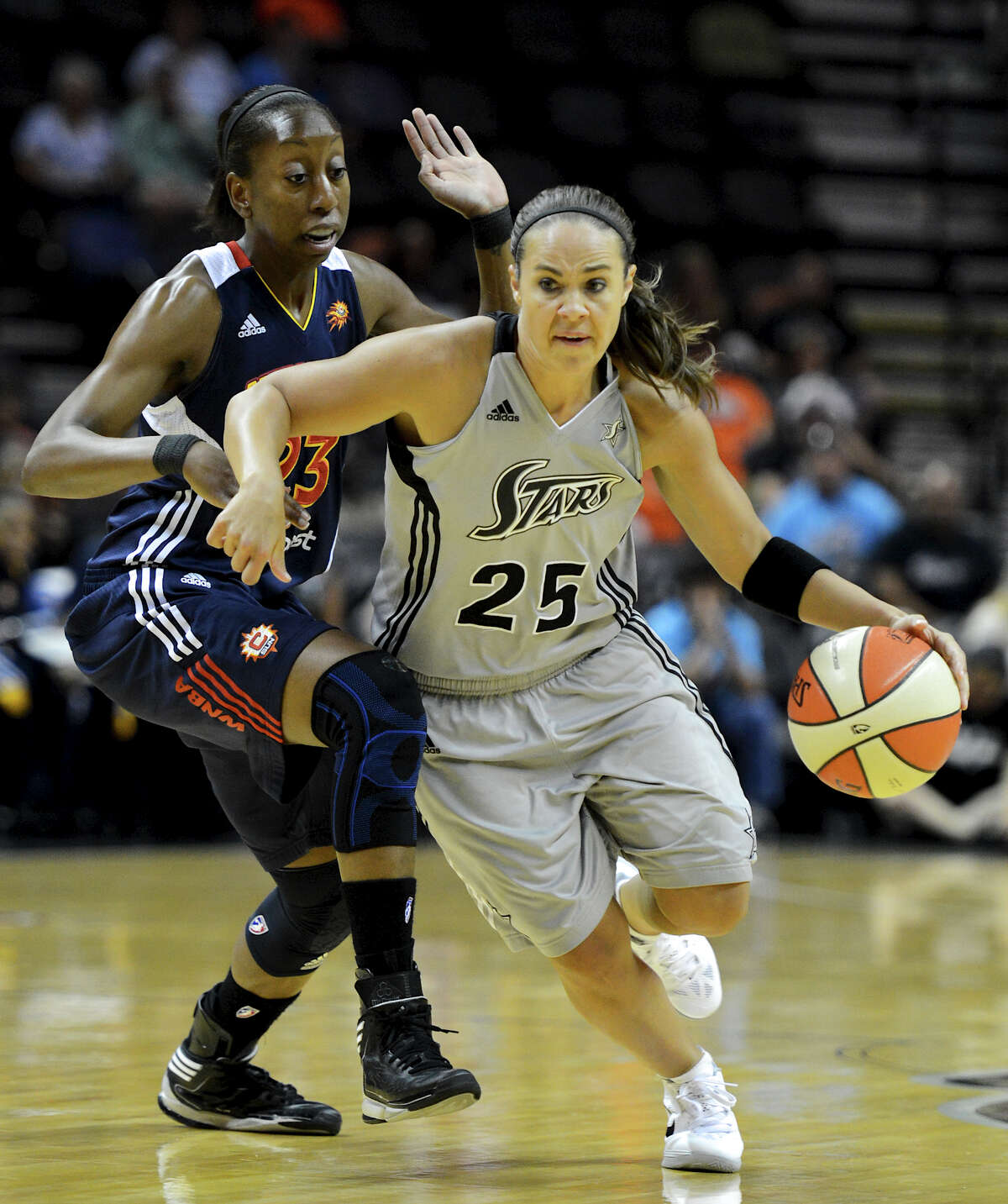 San Antonio Silver Stars' Becky Hammon (25) dribbles the ball around Connecticut Sun's Allison Hightower (23) during a WNBA game between the San Antonio Silver Stars and the Connecticut Sun on August 30, 2012 at the AT&T Center in San Antonio Texas. John Albright / Special to the Express-News.