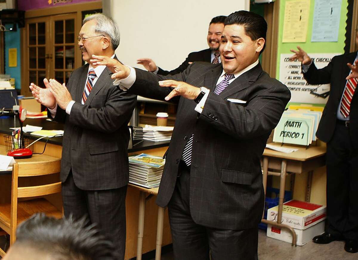 Mayor Ed Lee (left) and the new superintendent Richard Carranza (right) visiting a classmate at Everett Middle School in San Francisco, Calif., as students introduce themselves on the first day of school on Monday, August 20, 2012.