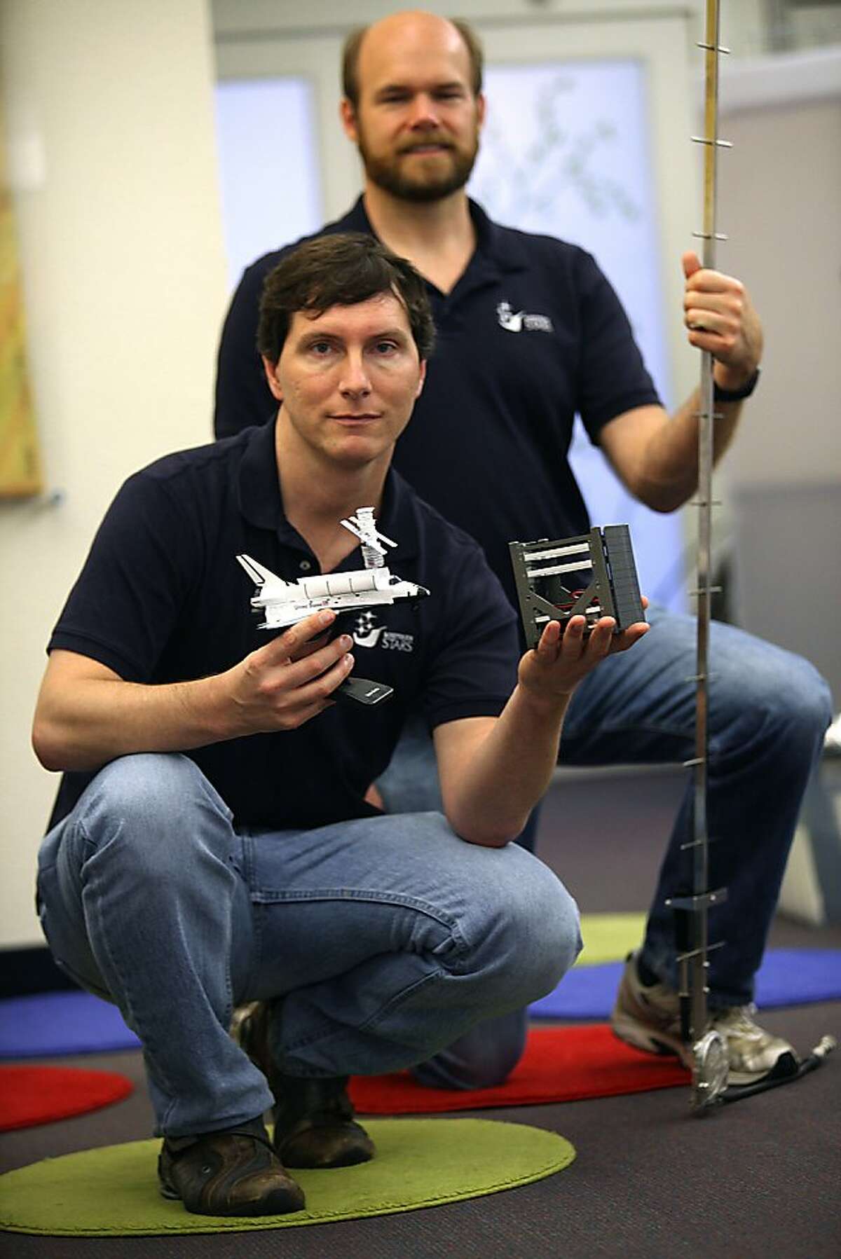 Founder Tim DeBenedictis (front) and engineer Chris Phoenix (behind) with a Yagi antenna, show the SkyCube (middle) in San Francisco, Calif., on Tuesday, August 21, 2012. Tim has been writing astronomy software since his high school days, and part of his inspiration was seeing the last shuttle flight at Fort Canaveral.