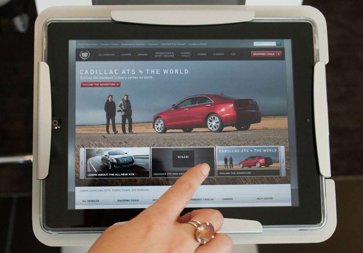 Left: Tech stations with iPads are in place at Stewart Cadillac in Midtown, so customers can learn about Cadillac technology.