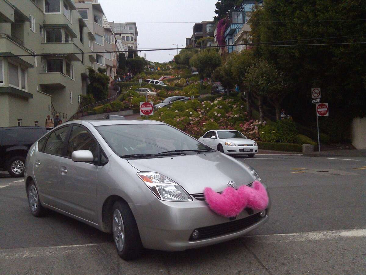 A car that is part of a new SF car service called Lyft. The drivers put these fuzzy pink mustaches on their cars to identify themselves.