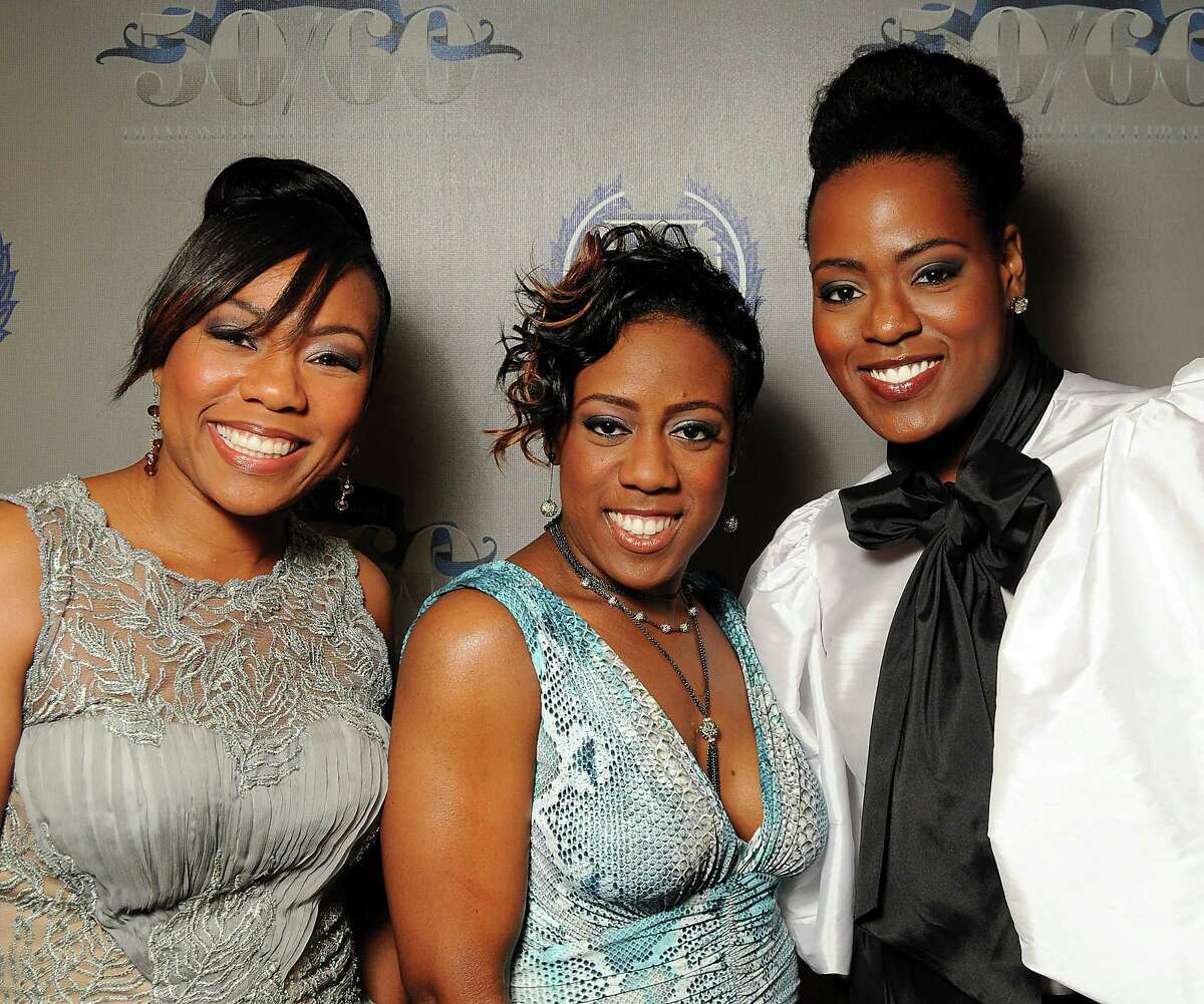 From left: Sisters Tina Egans, Irishea Hilliard and Preashea Hilliard at a gala celebrating 50 years of ministry for Bishop I.V. Hilliard at the New Light Christian Church August 31,2012.(Dave Rossman/For the Chronicle)