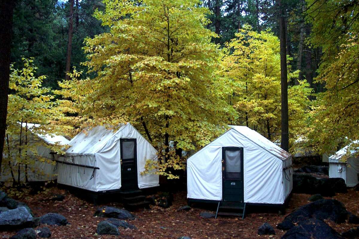 In this undated photo provided by DNC Parks and Resorts at Yosemite, Inc., are tent cabins in the fall at Yosemite National Park in California. Yosemite officials are expanding their efforts notify visitors to a complex of tent cabins who may have been exposed to a rare but potentially deadly rodent-carried virus. Officials said Wednesday they have notified 2,900 visitors who stayed in the Curry Village "Signature Cabins" since mid-May, up from 1,700 initially notified. (AP Photo/DNC Parks and Resorts at Yosemite, Inc.)