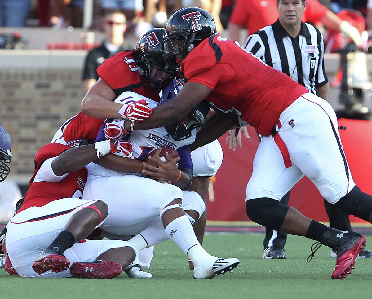Northwestern State's Brad Henderson is taken down by Texas Tech's Kerry Hyder,left, Jackson Richards(43) and Delvon Simmons, right, during their NCAA college football game in Lubbock, Texas, Saturday, Sept. 1, 2012. (AP Photo/Lubbock Avalanche-Journal,Zach Long)